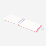 Spiral-bound floral office notebook by Flying Tiger Copenhagen with colorful flower cover and lined pages inside.