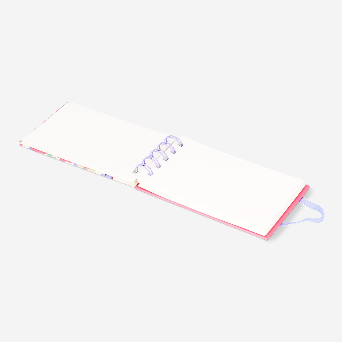 Spiral-bound floral office notebook by Flying Tiger Copenhagen with colorful flower cover and lined pages inside.