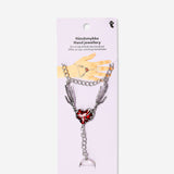 Silver textile hand jewelry with a red heart detail, stylish accessory featuring intricate design and vibrant color accents.