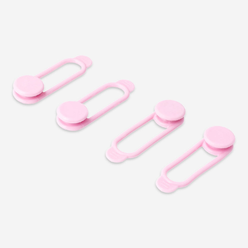 Set of four pink media cable organizers by Flying Tiger Copenhagen, neatly arranged to keep electronic cords tidy.