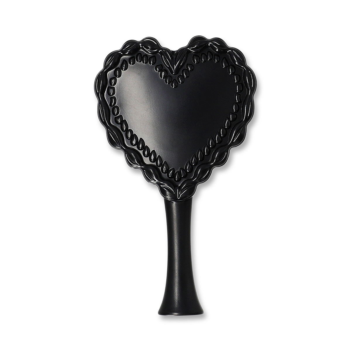 Red and black heart-shaped hairbrush from Flying Tiger Copenhagen for personal care and styling.