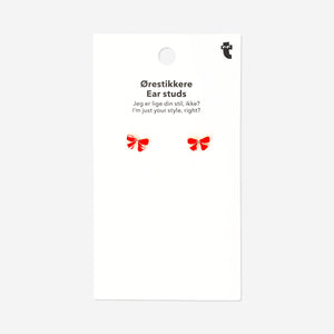 Red fabric bow ear studs by Flying Tiger Copenhagen featuring textile design, perfect for a cute and stylish accessory.