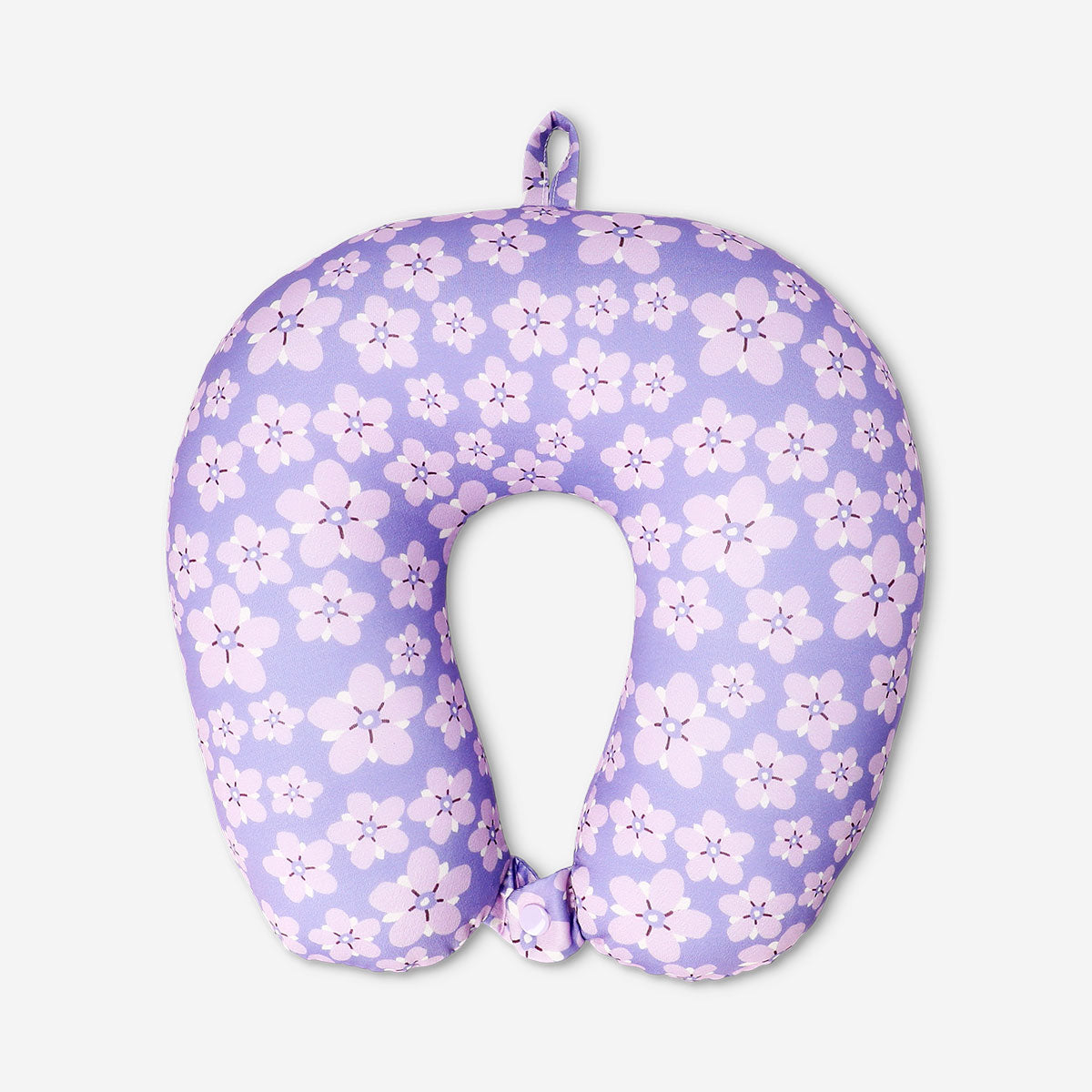 Purple floral travel pillow by Flying Tiger Copenhagen, showing soft fabric with a vibrant floral pattern for comfortable travel.