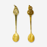 Two kitchen spoons with ski village design from Flying Tiger Copenhagen, featuring detailed winter village illustrations.