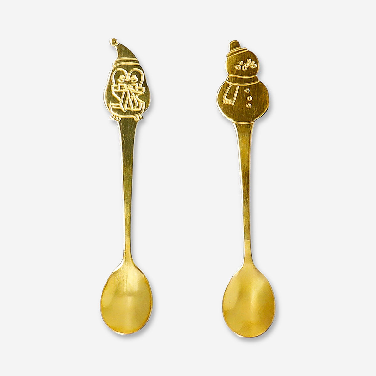 Two kitchen spoons with ski village design from Flying Tiger Copenhagen, featuring detailed winter village illustrations.