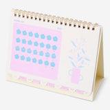 Monthly floral desk calendar for 2027 with stickers, designed for office use by Flying Tiger Copenhagen, featuring colorful floral illustrations.