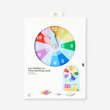 Wooden teaching clock toy by Flying Tiger Copenhagen showing colorful hour and minute hands, perfect for learning time.