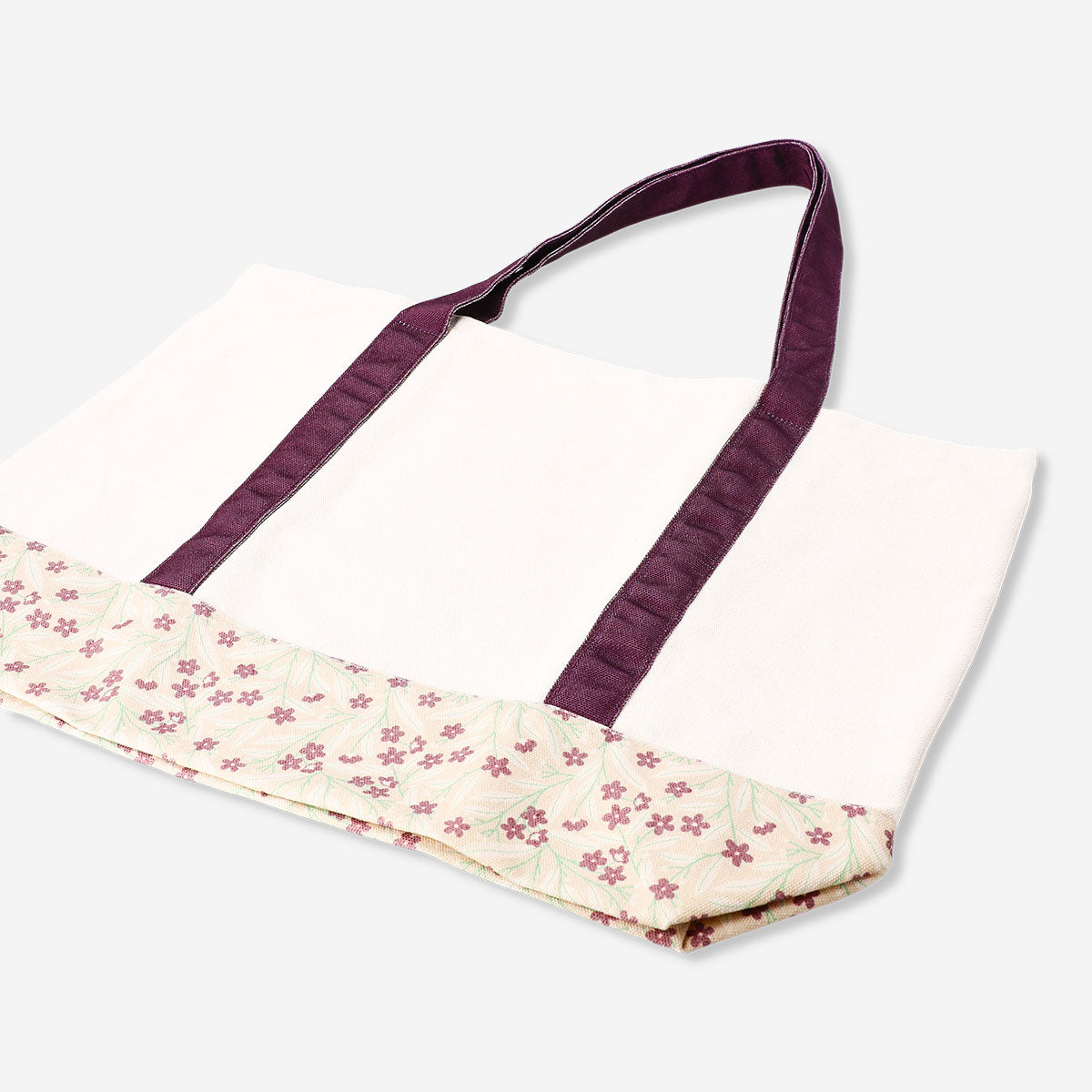 Textile shopper bag with floral pattern and burgundy strap, stylish and lightweight for everyday use.