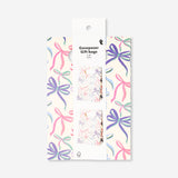Two office gift bags with bows from Flying Tiger Copenhagen, featuring decorative paper and ribbon accents for wrapping presents.