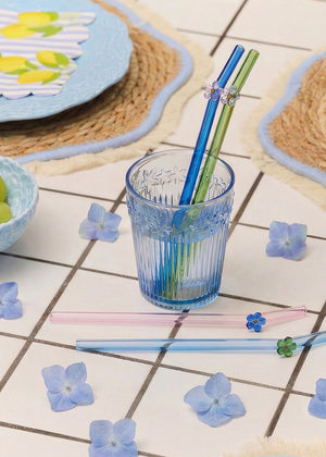 Set of four glass straws with colorful flower designs, ideal for eco-friendly kitchen use by Flying Tiger Copenhagen