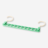 Green hanger hook for home organization by Flying Tiger Copenhagen, featuring a simple, functional design for hanging items.