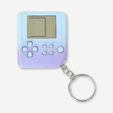 Flying Tiger Copenhagen mini game machine keyring featuring a compact gadget with multiple fun games on a colorful design.
