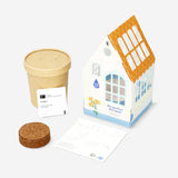 Home grow kit for marigolds by Flying Tiger Copenhagen, featuring marigold seeds, soil, and planting tools in a compact kit.