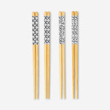Set of 8 Flying Tiger Copenhagen kitchen chopsticks with colorful printed designs on smooth wood.