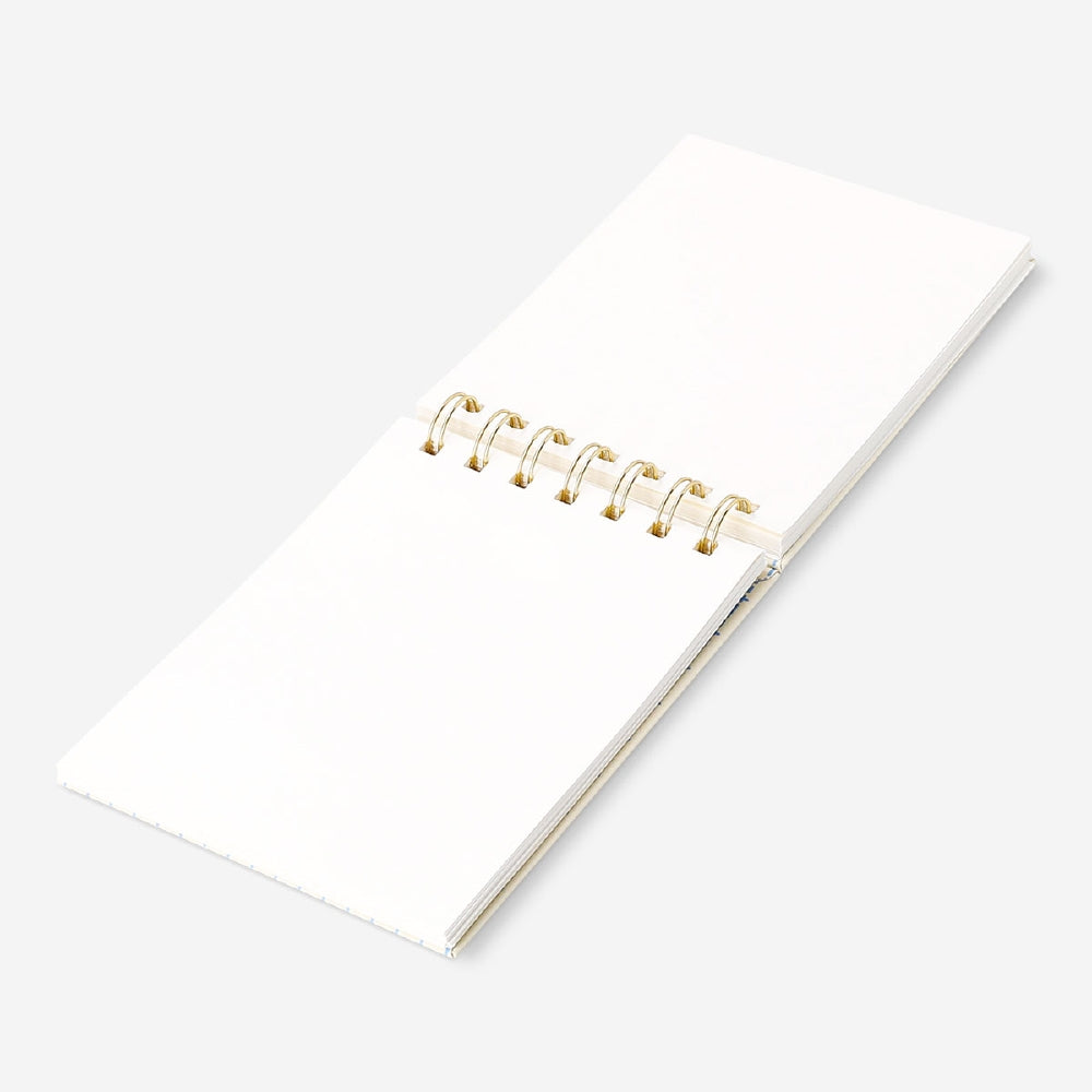 Spiral bound office notepad by Flying Tiger Copenhagen with lined pages for note-taking and organization.