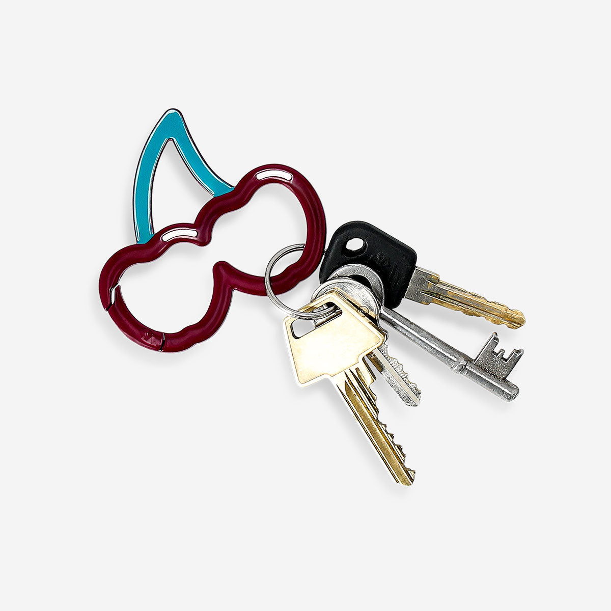 Flying Tiger Copenhagen cherry-shaped textile carabiner clipped to a keyring with colorful keys and accessories.