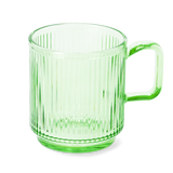 Flying Tiger Copenhagen matcha kit with green mug, bamboo whisk, and matcha powder for traditional tea preparation.
