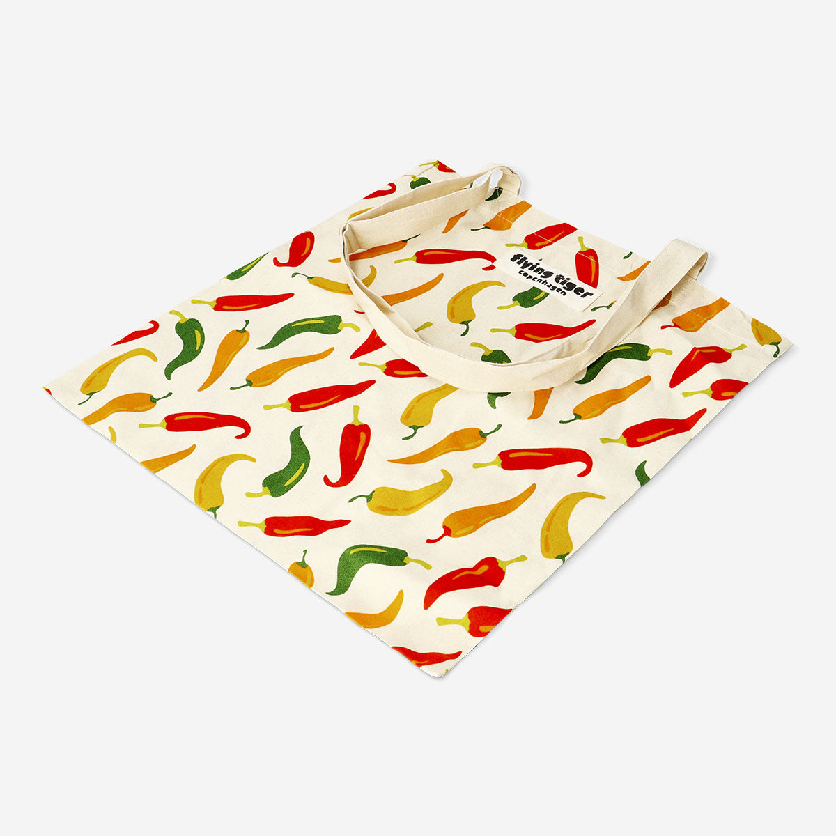 Textile tote bag with colorful chili pepper print from Flying Tiger Copenhagen, featuring vibrant red and green chili design.