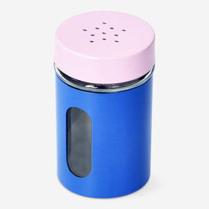 Pink and blue salt and pepper shakers in a kitchen setting, Flying Tiger Copenhagen brand, with a colorful ceramic design.
