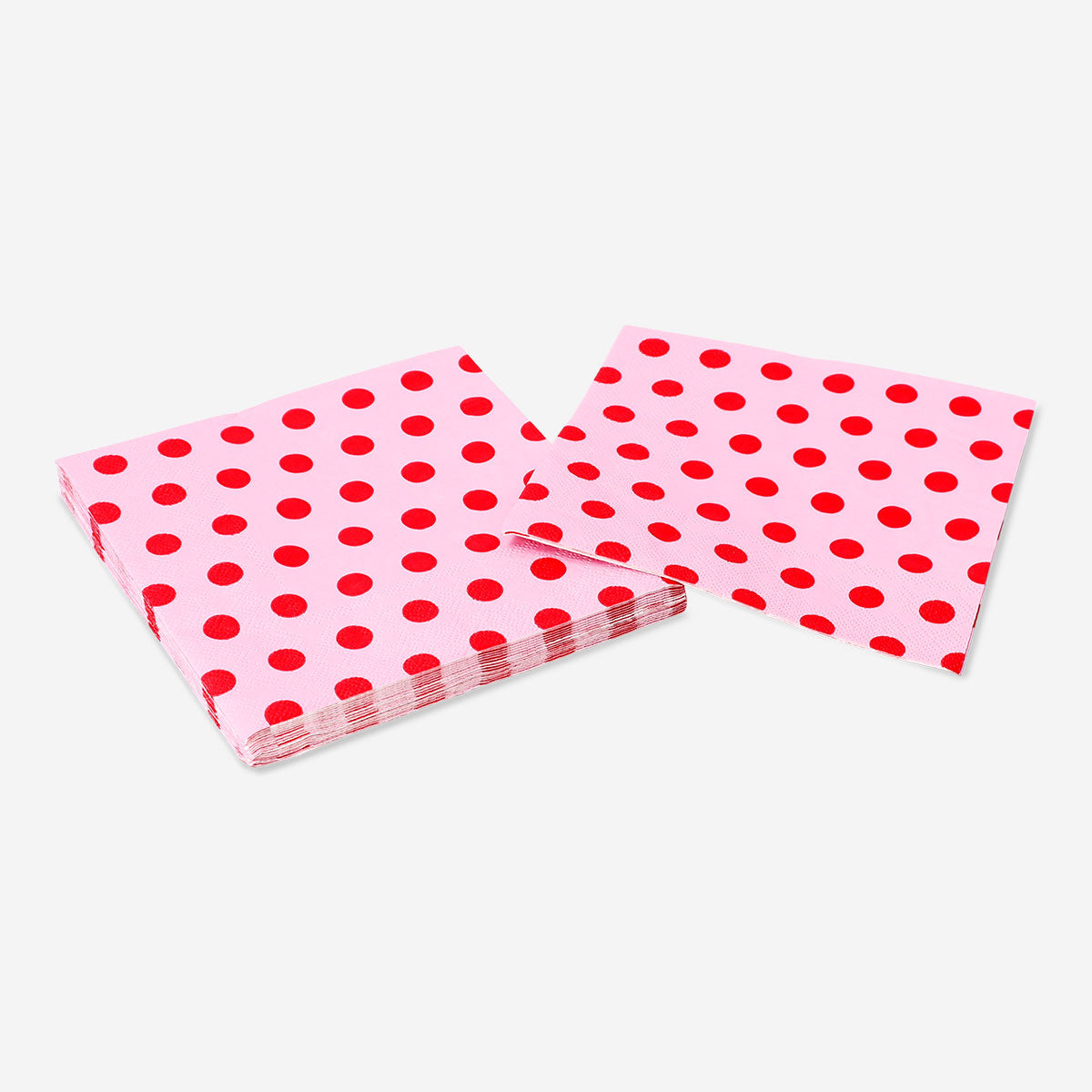 Pink paper napkins with red dots, 16-piece party set from Flying Tiger Copenhagen, shown folded on a table.