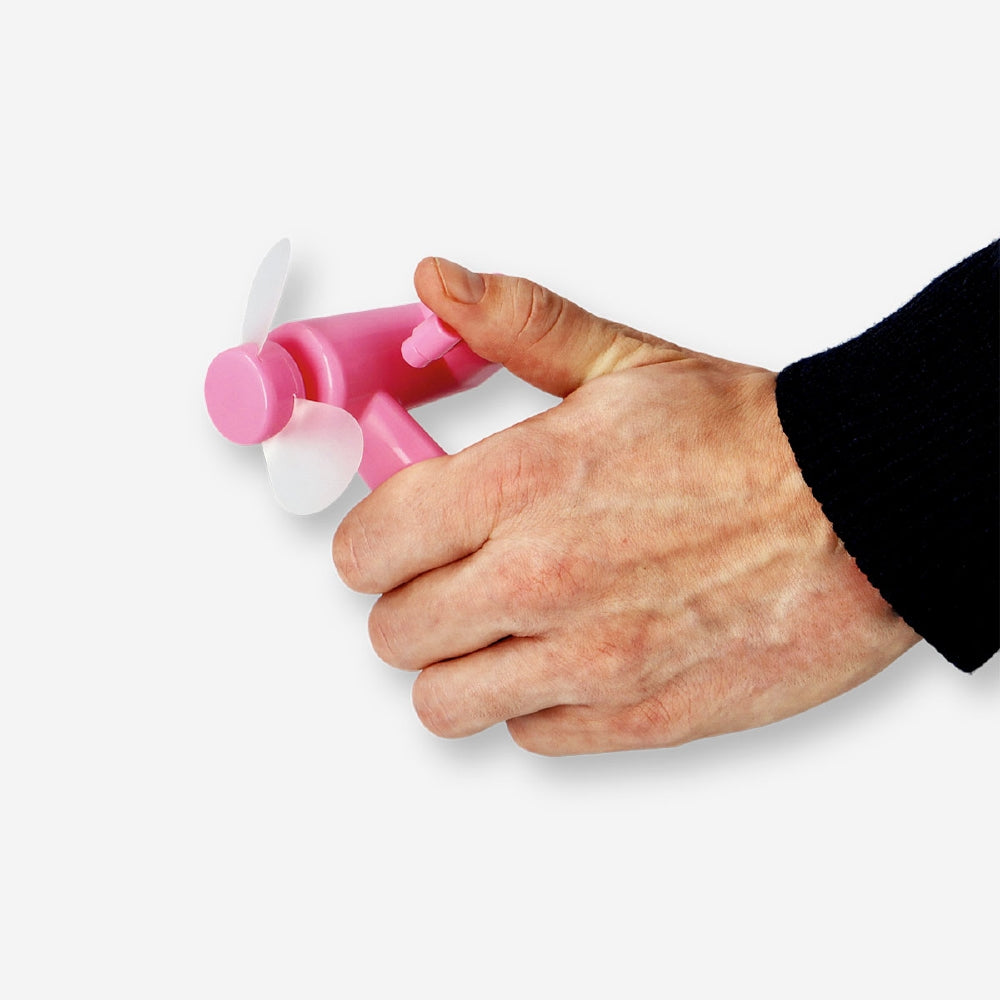 Pink handheld gadget fan by Flying Tiger Copenhagen, compact and portable with a sleek design, ideal for personal cooling.