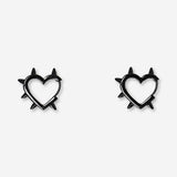 Black studded heart earrings made of textile, featuring a fashionable design from Flying Tiger Copenhagen.