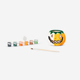 DIY pumpkin tealight holder craft kit by Flying Tiger Copenhagen with paint, brush, and materials for decorating a pumpkin.