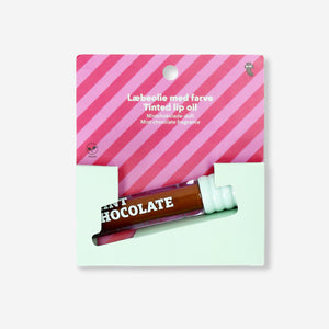 Flying Tiger Copenhagen mint chocolate lip oil in a clear tube with mint and chocolate scent, perfect for nourishing lips.