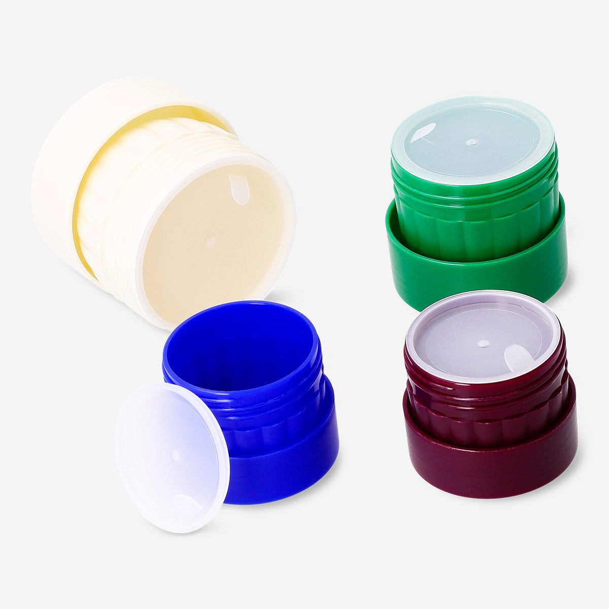 Set of four Flying Tiger Copenhagen travel containers with lids, ideal for toiletries and snacks during trips.
