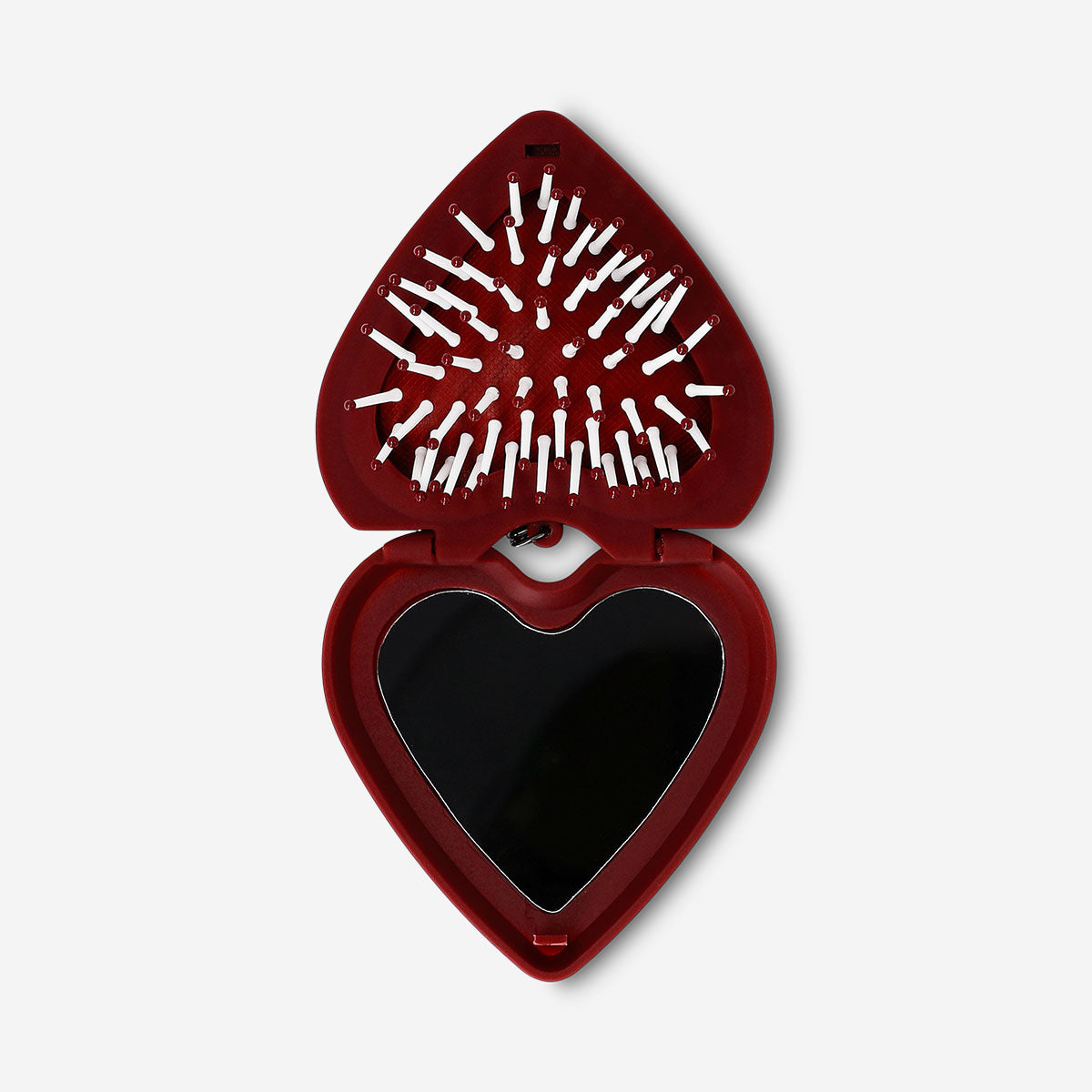 Foldable heart-shaped hairbrush with mirror by Flying Tiger Copenhagen, personal care accessory, compact and portable for styling on the go.
