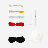 DIY crochet penguin craft from Flying Tiger Copenhagen, showcasing a handmade black and white penguin with orange beak and flippers.