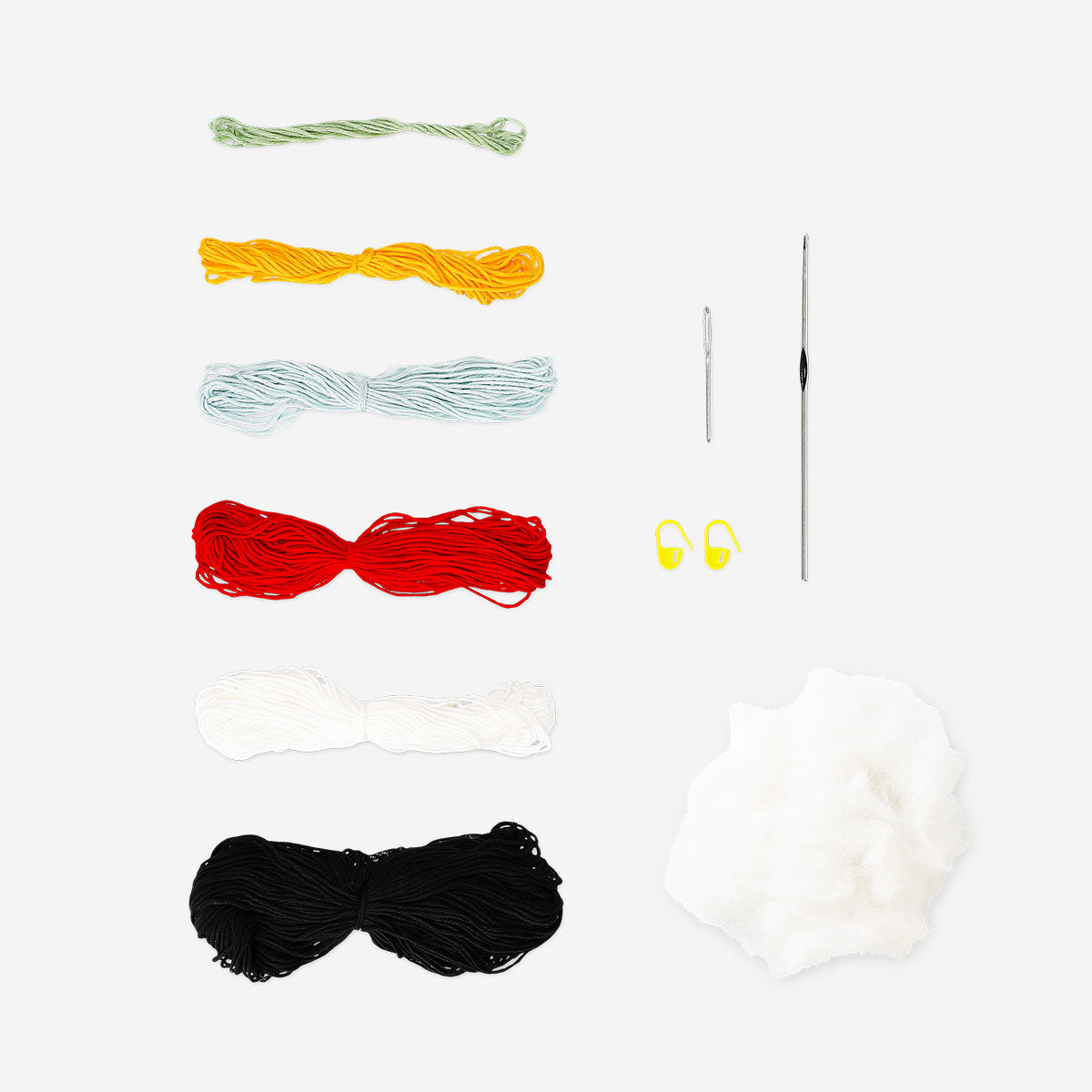 DIY crochet penguin craft from Flying Tiger Copenhagen, showcasing a handmade black and white penguin with orange beak and flippers.