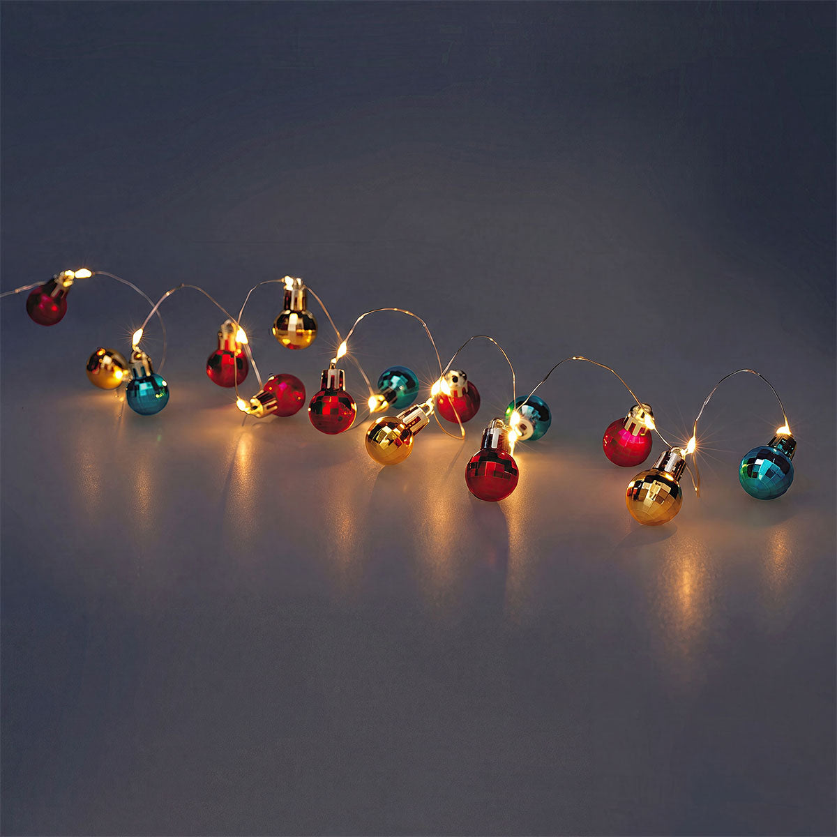 Multi-colored bauble string lights from Flying Tiger Copenhagen, decorative home lighting with festive, colorful glass ornaments.