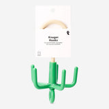 Green hook for scarves and belts from Flying Tiger Copenhagen, designed for home organization and wall mounting.