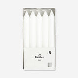 Set of 10 white dinner candles from Flying Tiger Copenhagen, ideal for home table decor and special occasions.