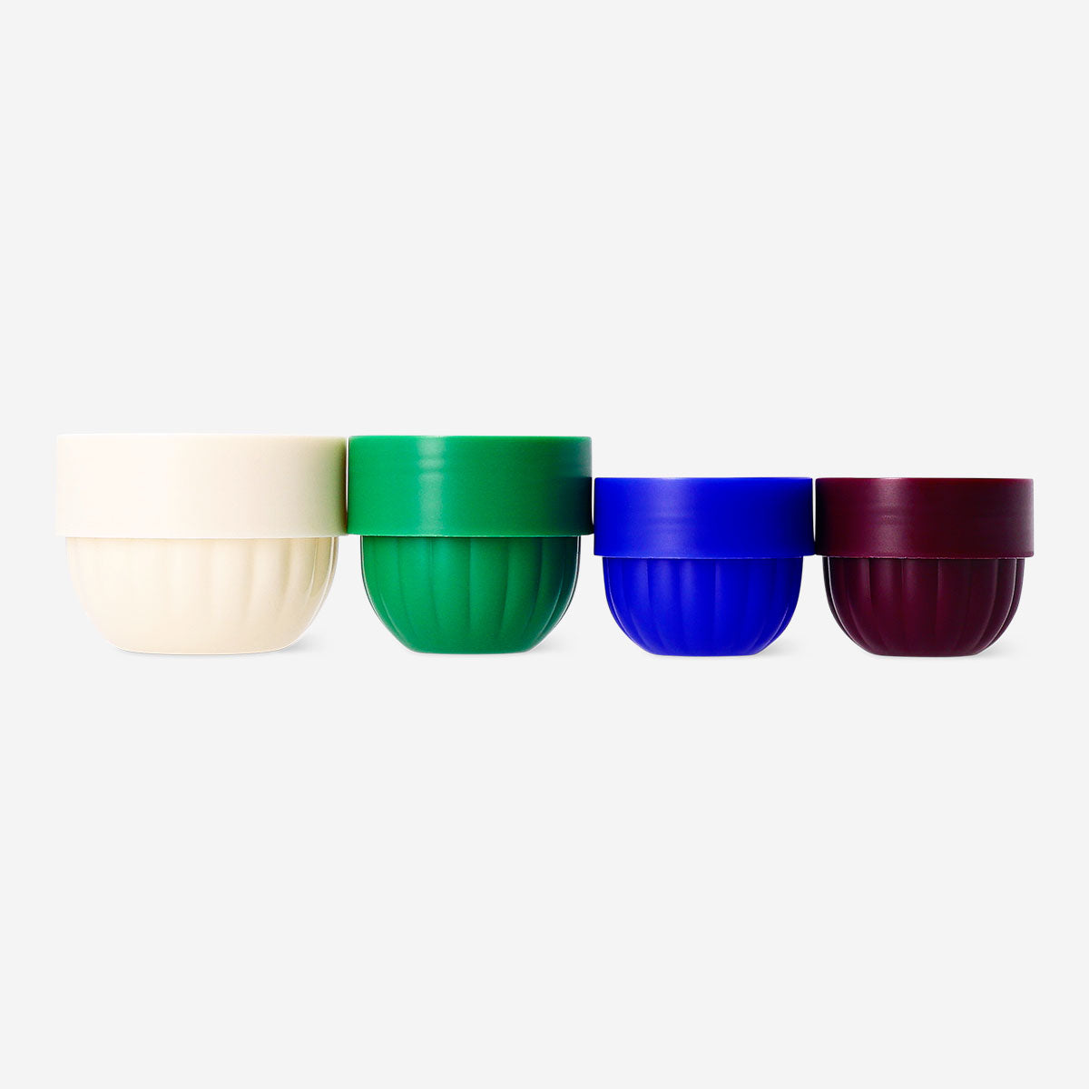 Set of four Flying Tiger Copenhagen travel containers with lids, ideal for organizing toiletries and snacks on the go.