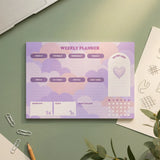 Purple Flying Tiger Copenhagen weekly office planner with goal-setting pages and organized layout.