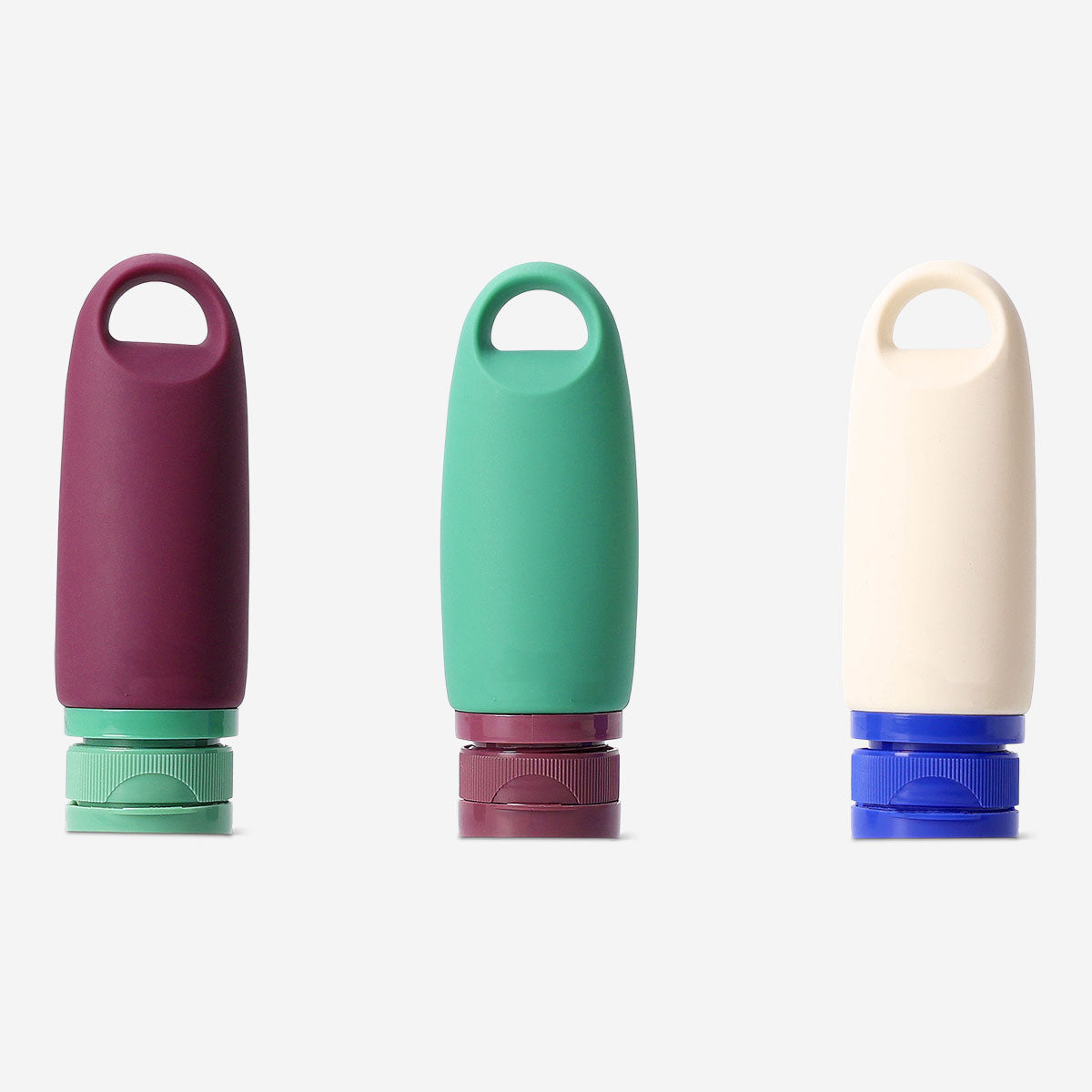 Set of three Flying Tiger Copenhagen silicone travel bottles with hangers, ideal for toiletries on the go.