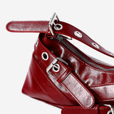 Red textile shoulder bag with buckle details from Flying Tiger Copenhagen, featuring a stylish and functional design.
