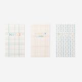 Set of three Flying Tiger Copenhagen office planners with colorful covers and organized pages for daily scheduling and note-taking.