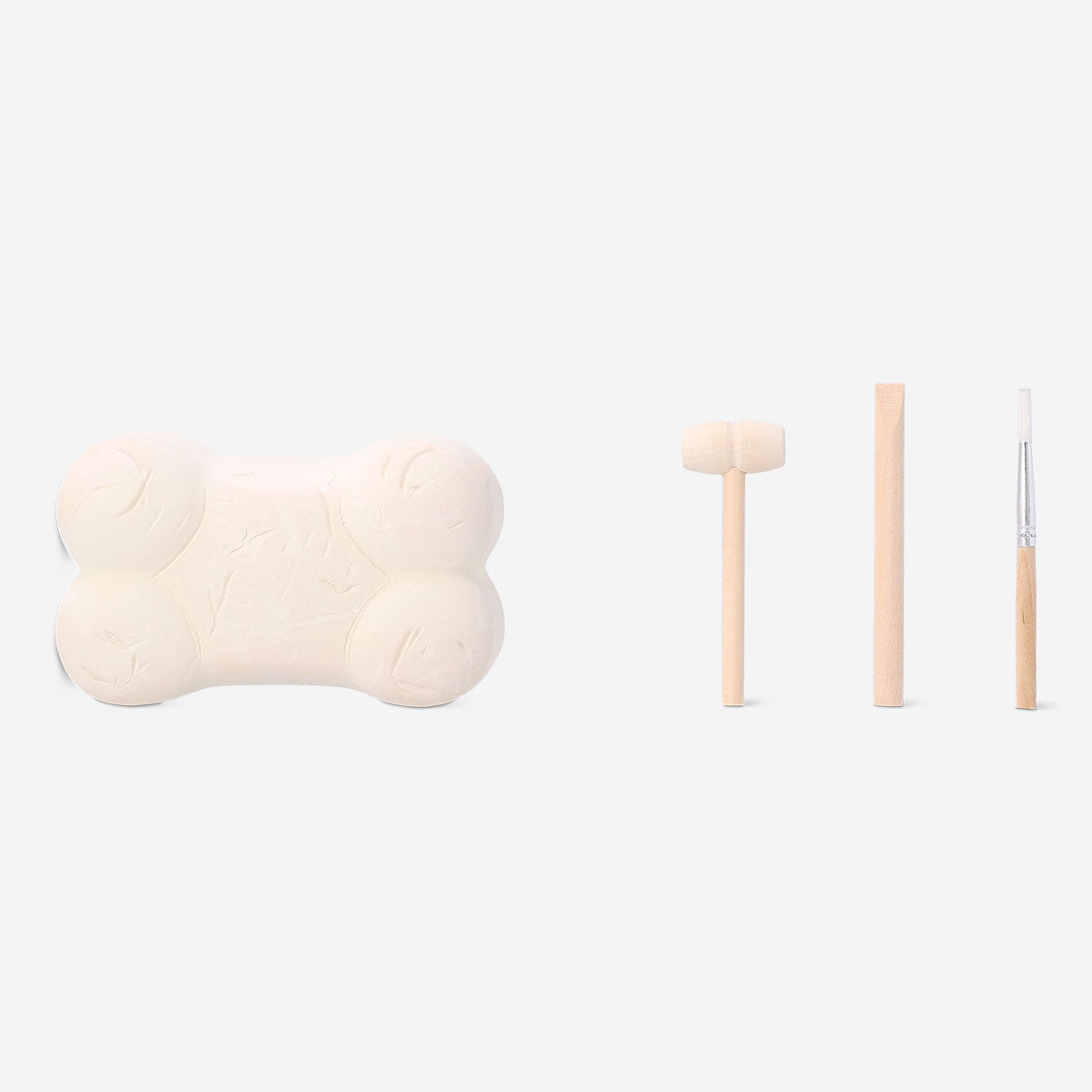 Toy excavation kit featuring bone fossil replica from Flying Tiger Copenhagen, includes tools for digging and exploring fossil discovery.
