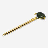 Gold Flying Tiger Copenhagen ballpoint pen with integrated facial roller, sleek office accessory for writing and skincare.