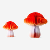 Two honeycomb paper gradient mushroom decorations for party from Flying Tiger Copenhagen, featuring colorful, textured paper mushrooms.