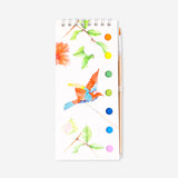 Flying Tiger Copenhagen watercolouring book with paint set, featuring colorful pages and art supplies for creative hobby painting.