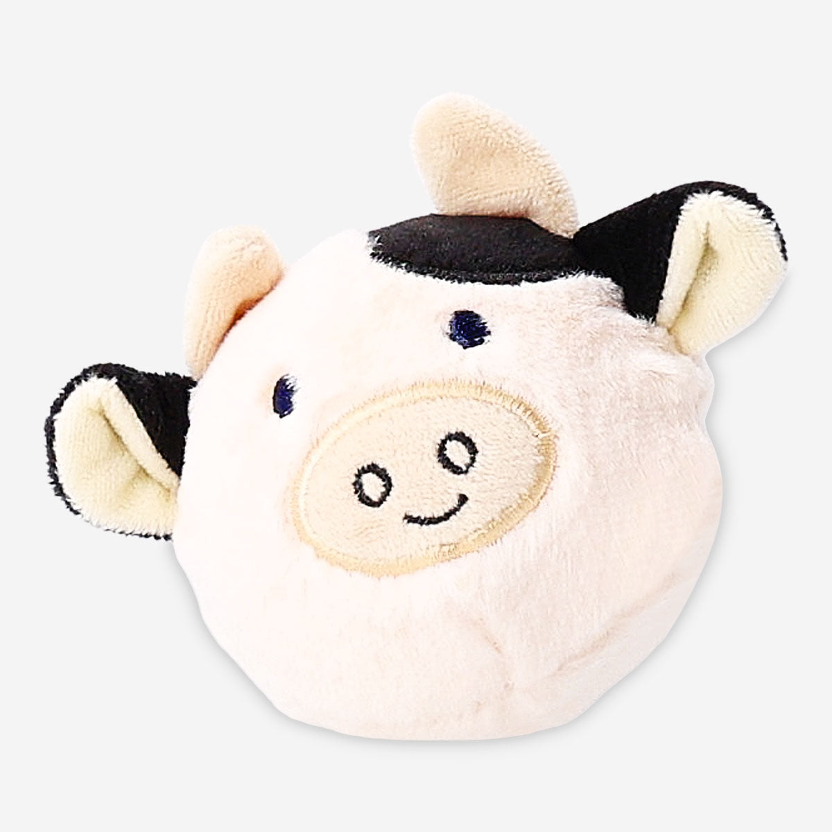 Soft plush cow ball toy from Flying Tiger Copenhagen, featuring a round shape with cow print and adorable facial details.