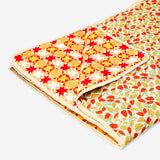 Quilted autumnal blanket by Flying Tiger Copenhagen, 170x130 cm, with warm, cozy fall-inspired patterned fabric on a bed.