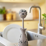 Flying Tiger Copenhagen cat-shaped kitchen washing-up brush with handle for easy dish cleaning.