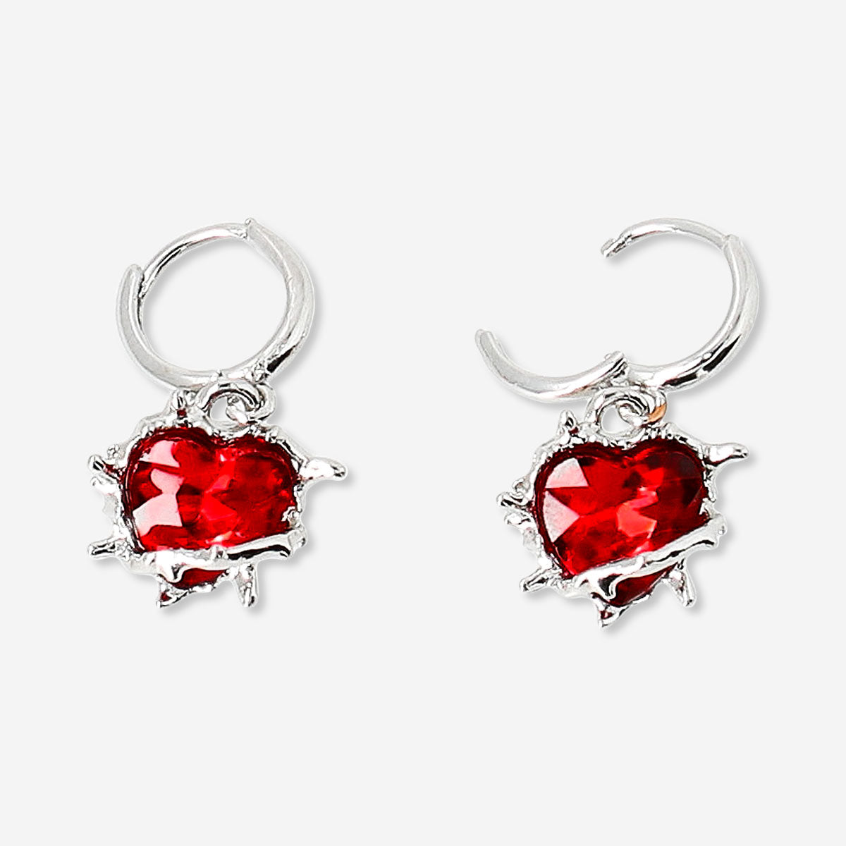 Red heart-shaped textile earrings with spike accents, stylish hanging earrings by Flying Tiger Copenhagen.