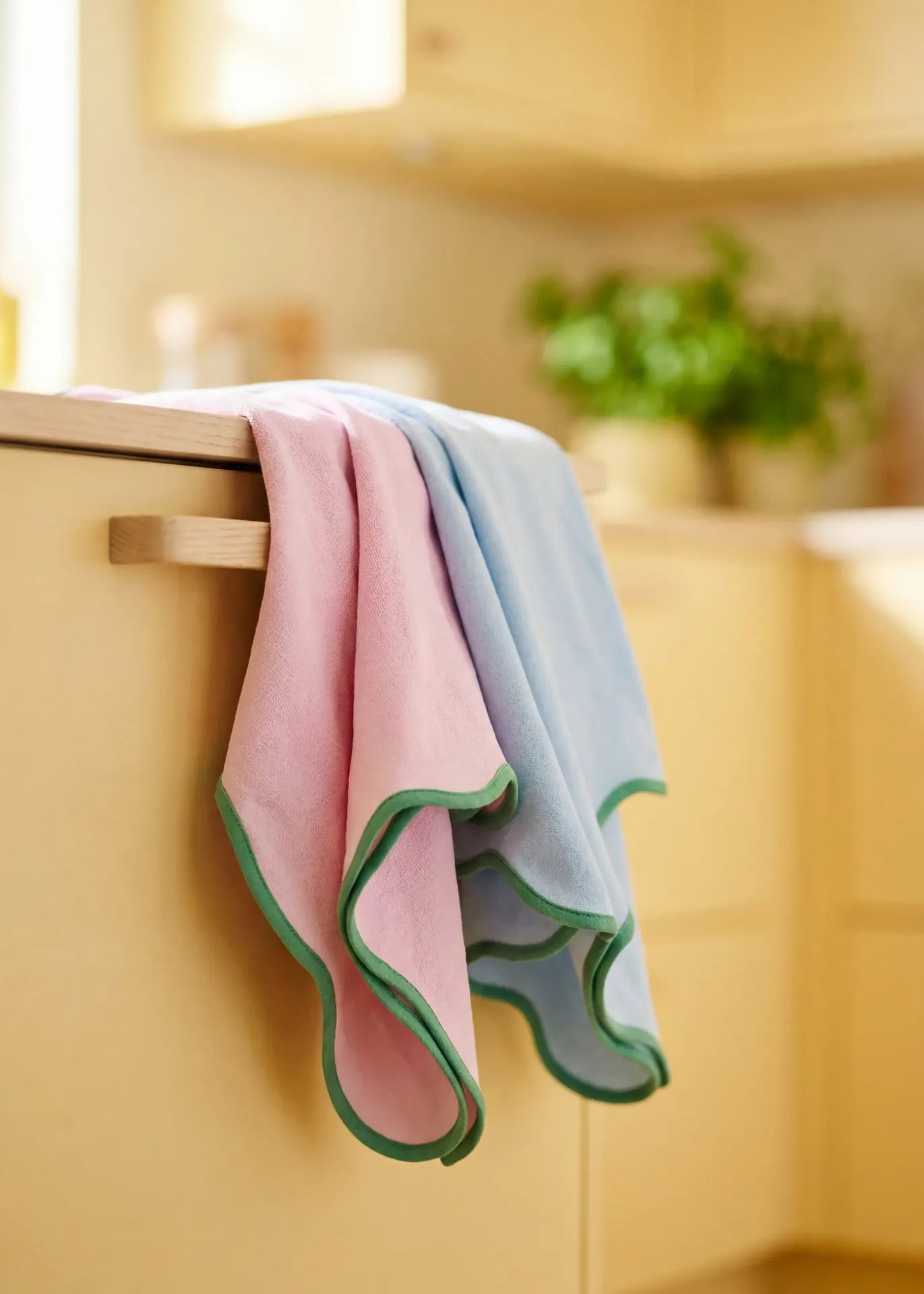 Set of two Flying Tiger Copenhagen kitchen tea towels with scalloped edges, featuring soft fabric and decorative hem detailing.