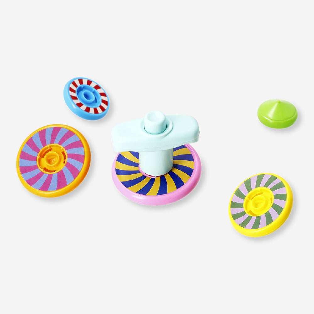 Colorful stackable spinning tops toy from Flying Tiger Copenhagen, arranged in a playful display on a white background.